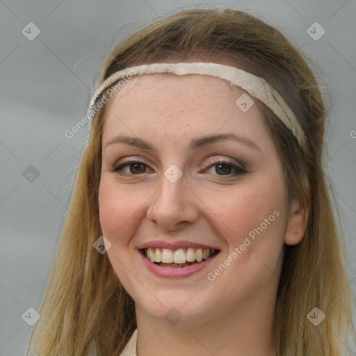 Joyful white young-adult female with long  brown hair and grey eyes