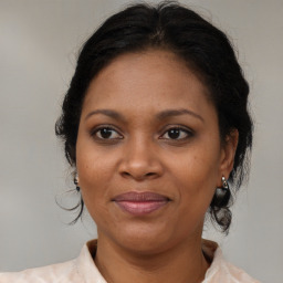 Joyful black adult female with medium  brown hair and brown eyes