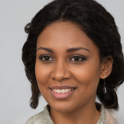 Joyful black young-adult female with medium  brown hair and brown eyes