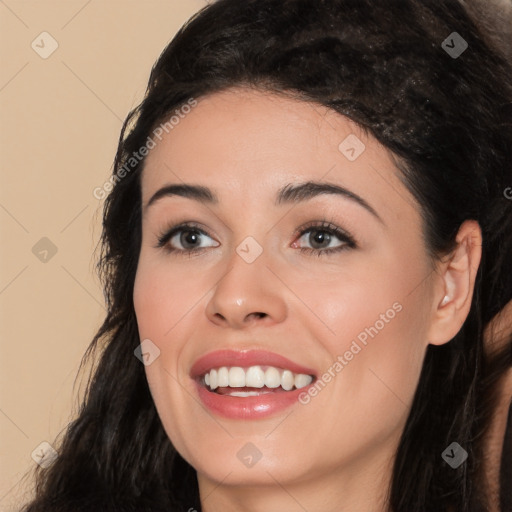 Joyful white young-adult female with long  black hair and brown eyes