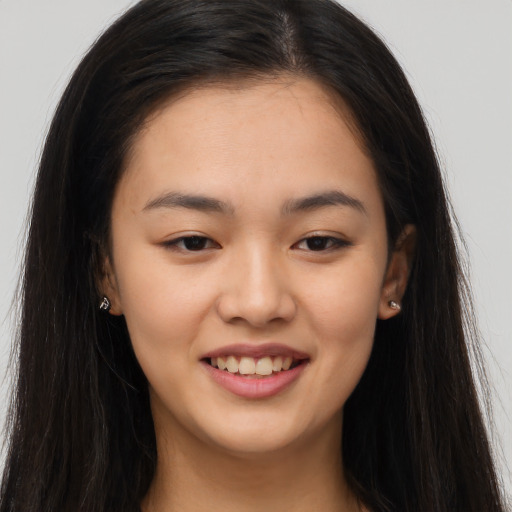 Joyful asian young-adult female with long  brown hair and brown eyes