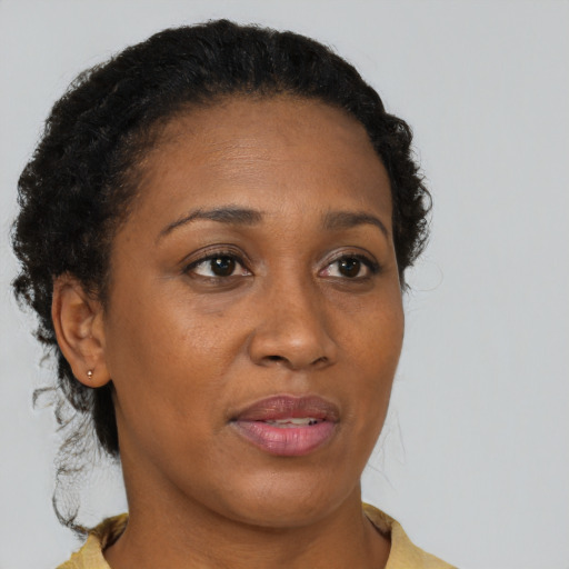 Neutral black adult female with medium  brown hair and brown eyes