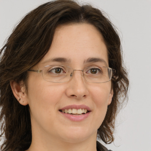 Joyful white adult female with medium  brown hair and green eyes