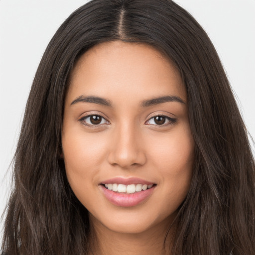 Joyful white young-adult female with long  brown hair and brown eyes