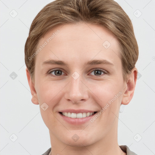 Joyful white young-adult female with short  brown hair and grey eyes