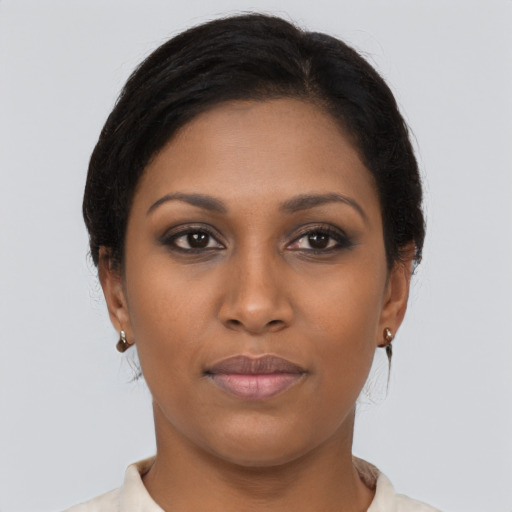 Joyful black young-adult female with medium  brown hair and brown eyes