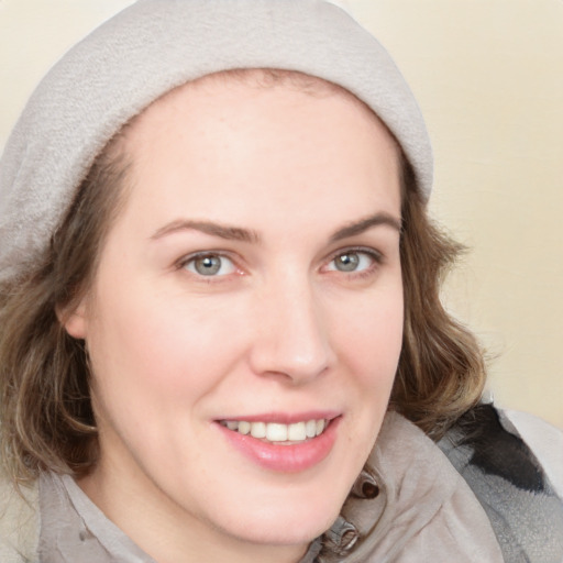 Joyful white young-adult female with medium  brown hair and blue eyes