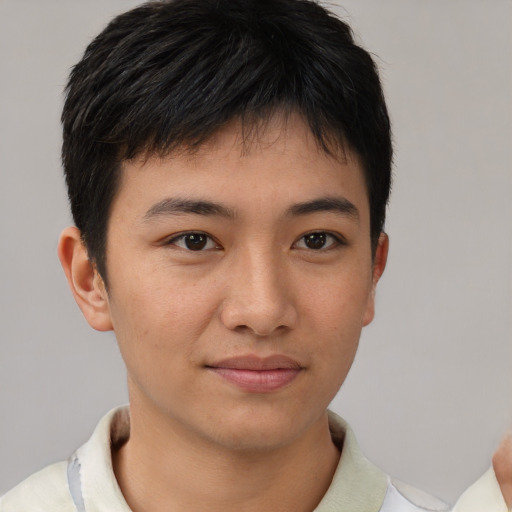Joyful asian young-adult male with short  brown hair and brown eyes