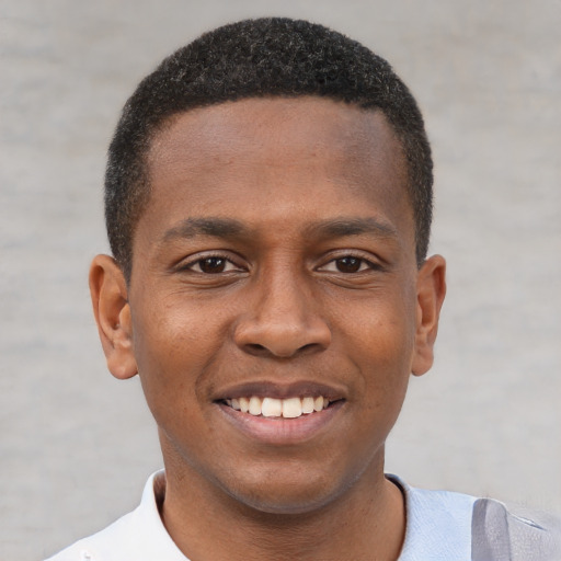 Joyful black young-adult male with short  brown hair and brown eyes