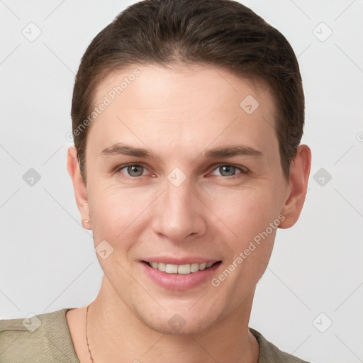 Joyful white young-adult female with short  brown hair and grey eyes