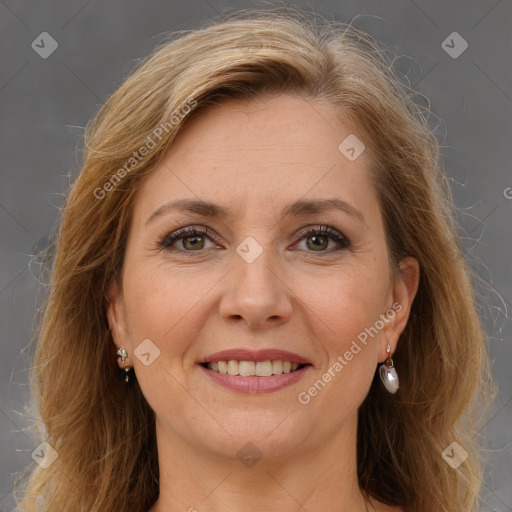 Joyful white adult female with long  brown hair and brown eyes