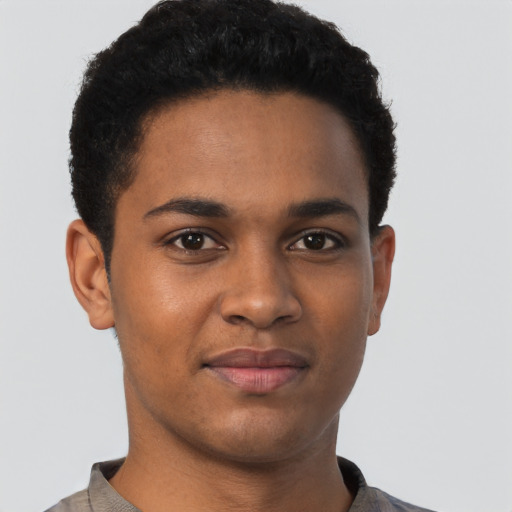 Joyful black young-adult male with short  brown hair and brown eyes