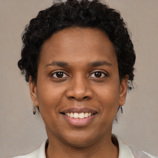 Joyful black young-adult female with short  brown hair and brown eyes