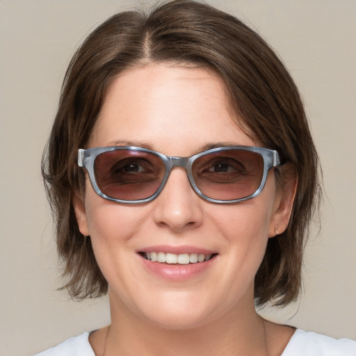 Joyful white young-adult female with medium  brown hair and blue eyes