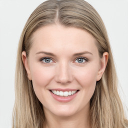 Joyful white young-adult female with long  brown hair and blue eyes