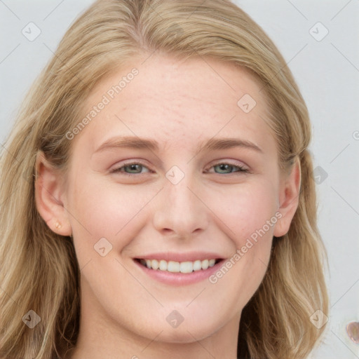 Joyful white young-adult female with long  brown hair and blue eyes