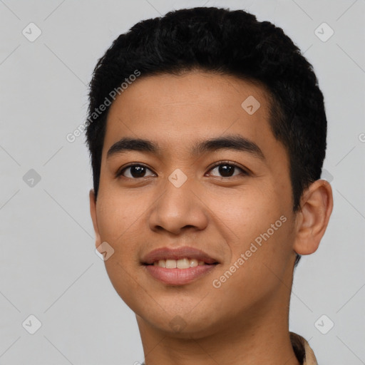 Joyful latino young-adult male with short  black hair and brown eyes