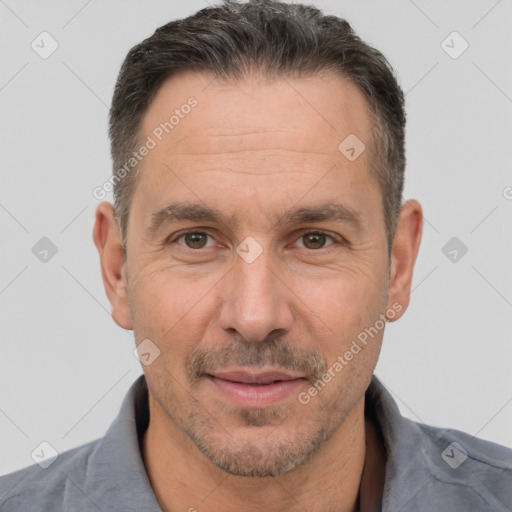 Joyful white adult male with short  brown hair and brown eyes