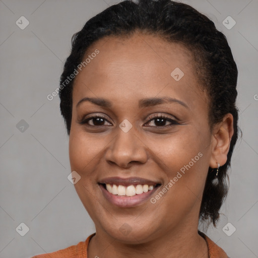 Joyful black young-adult female with short  brown hair and brown eyes