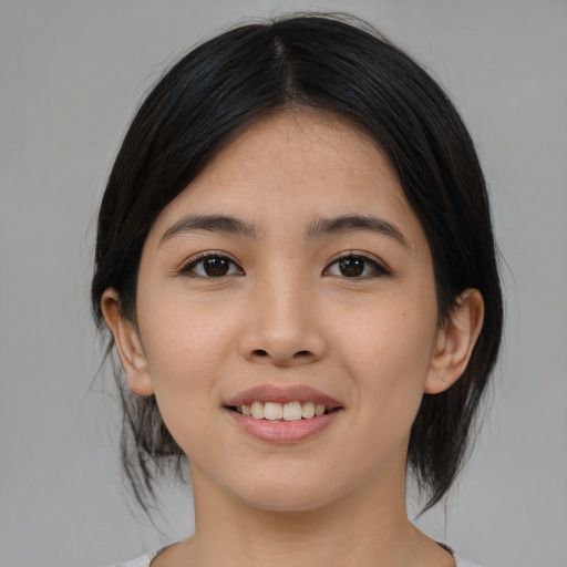 Joyful asian young-adult female with medium  black hair and brown eyes