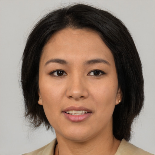 Joyful asian young-adult female with medium  brown hair and brown eyes