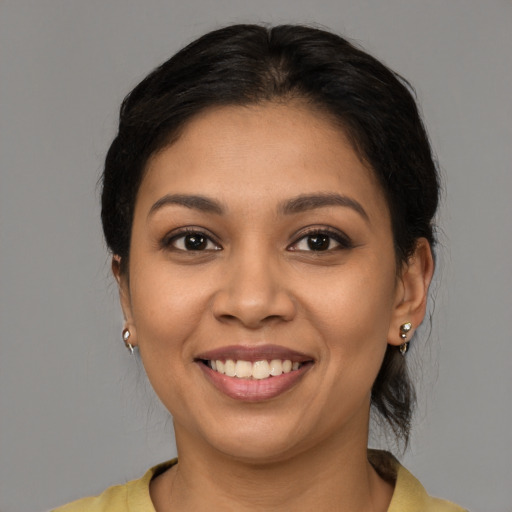 Joyful latino young-adult female with medium  brown hair and brown eyes