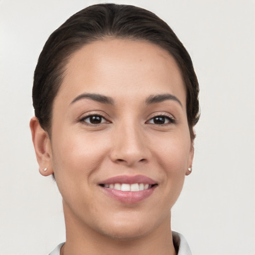 Joyful white young-adult female with short  brown hair and brown eyes