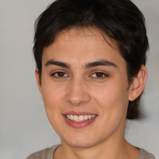 Joyful white young-adult female with short  brown hair and brown eyes