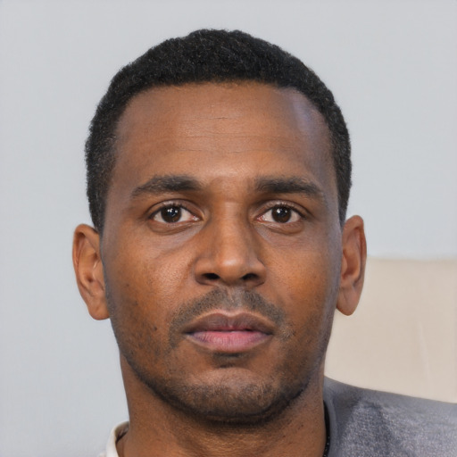 Neutral black young-adult male with short  black hair and brown eyes