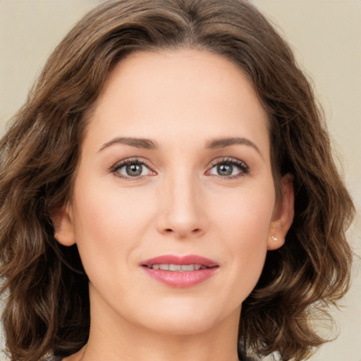 Joyful white young-adult female with medium  brown hair and green eyes