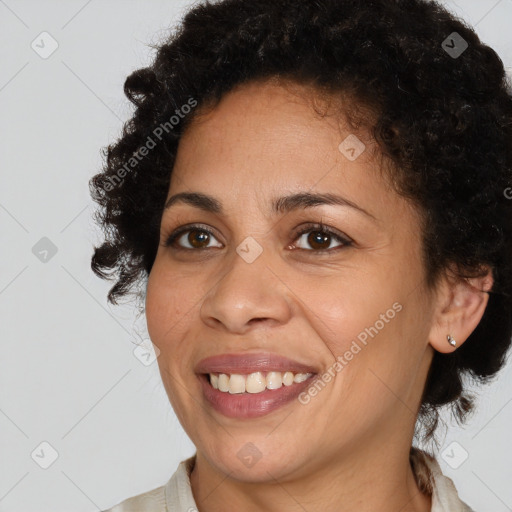 Joyful black young-adult female with medium  brown hair and brown eyes