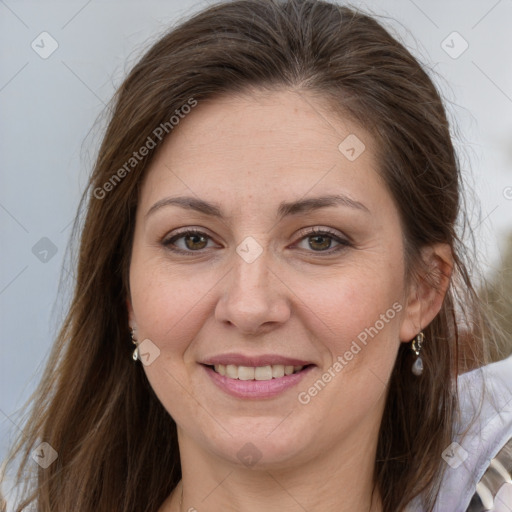 Joyful white adult female with long  brown hair and brown eyes