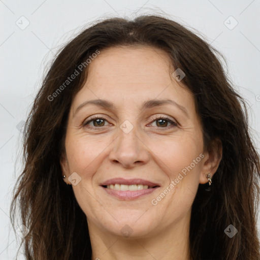 Joyful white adult female with long  brown hair and brown eyes