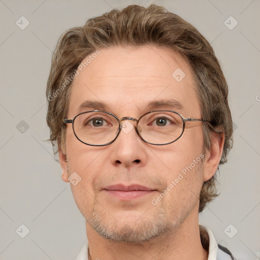 Joyful white adult male with short  brown hair and grey eyes