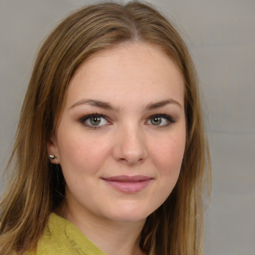 Joyful white young-adult female with medium  brown hair and grey eyes