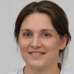 Joyful white adult female with medium  brown hair and brown eyes