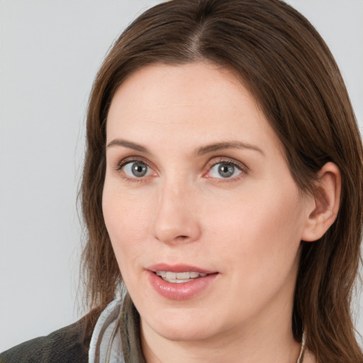 Joyful white young-adult female with medium  brown hair and grey eyes