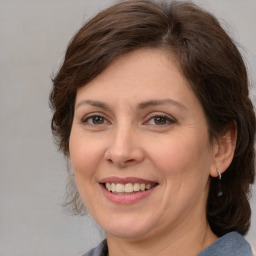 Joyful white adult female with medium  brown hair and brown eyes