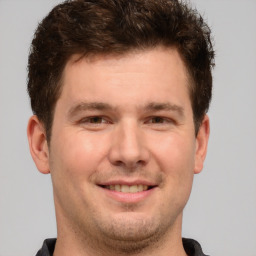 Joyful white young-adult male with short  brown hair and brown eyes