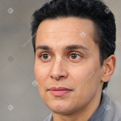 Joyful white adult male with short  black hair and brown eyes