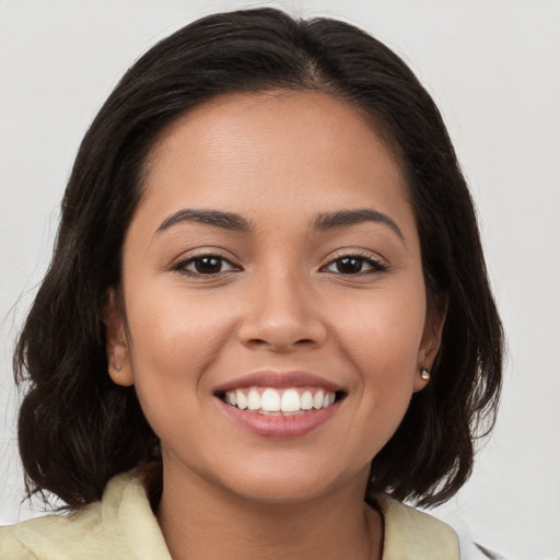 Joyful white young-adult female with medium  brown hair and brown eyes