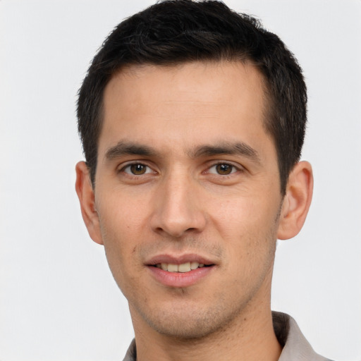 Joyful white young-adult male with short  black hair and brown eyes