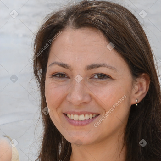 Joyful white adult female with long  brown hair and brown eyes