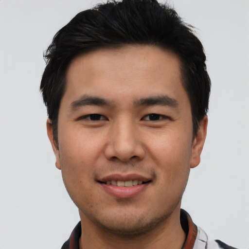 Joyful asian young-adult male with short  black hair and brown eyes