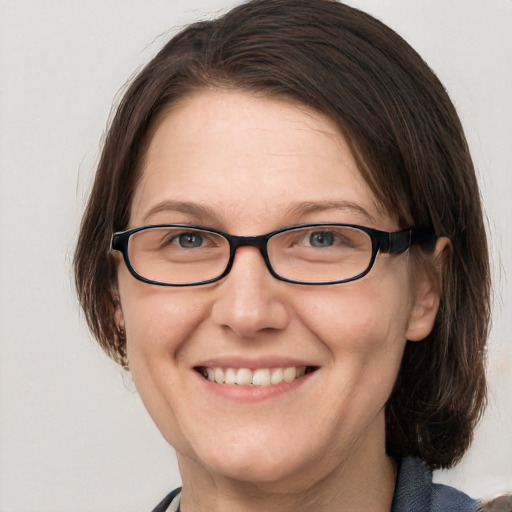 Joyful white adult female with medium  brown hair and blue eyes