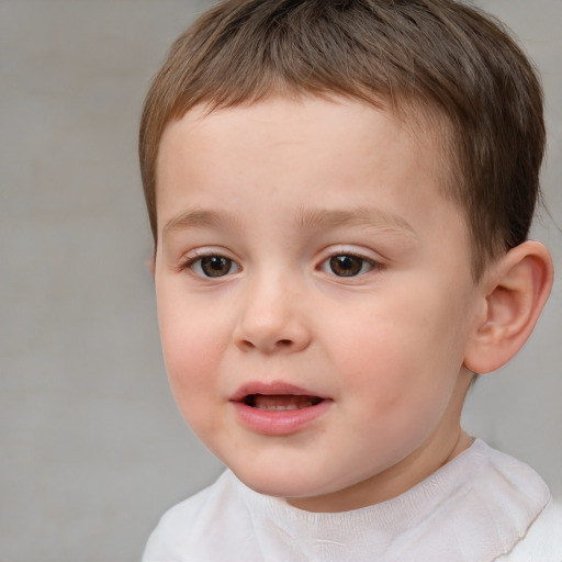 Joyful white child male with short  brown hair and brown eyes