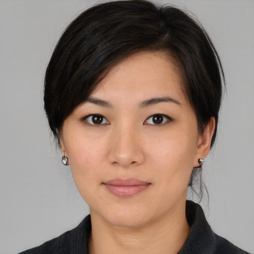 Joyful asian young-adult female with medium  black hair and brown eyes