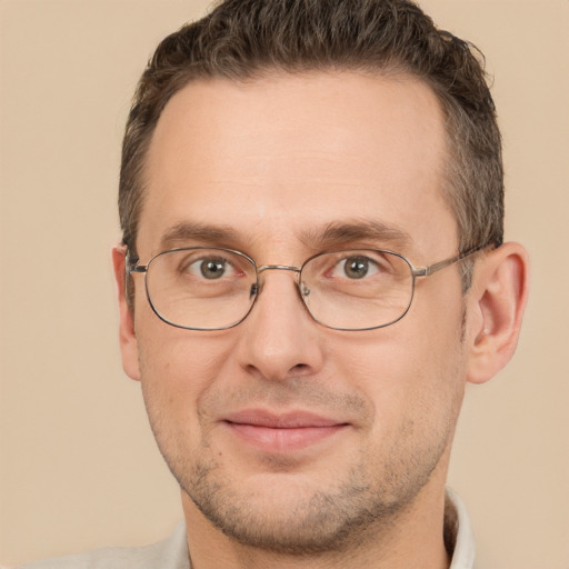 Joyful white adult male with short  brown hair and brown eyes