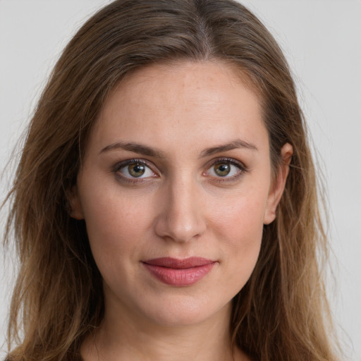 Joyful white young-adult female with long  brown hair and green eyes