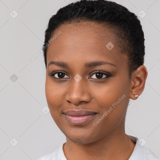 Joyful black young-adult female with short  black hair and brown eyes